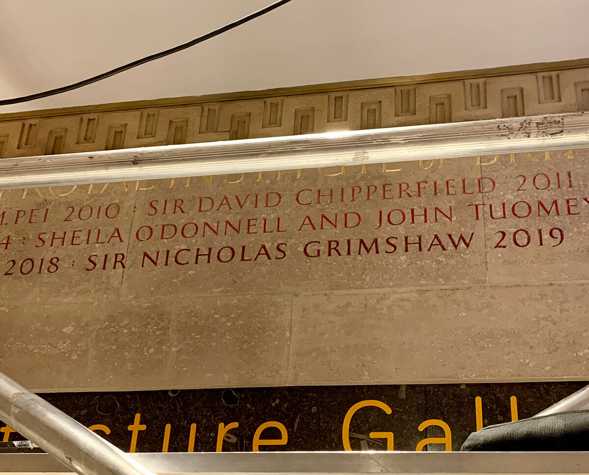 Name carving takes place on RIBA Royal Gold Medal wall